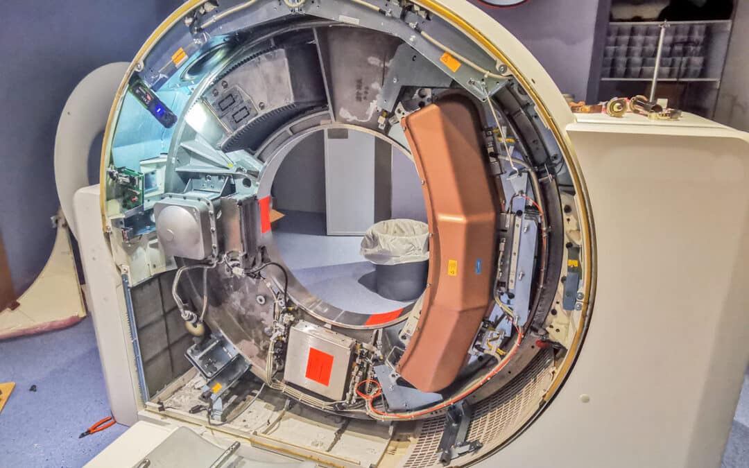 A scanning machine with the side panel removed exposing the mechanical components inside.