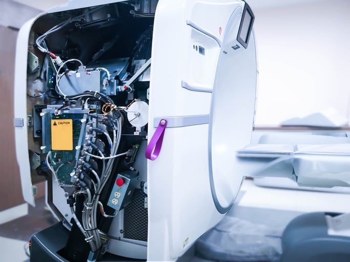 Interior of a CT scanner showing various wires and a motor inside of a sterile plastic covering.