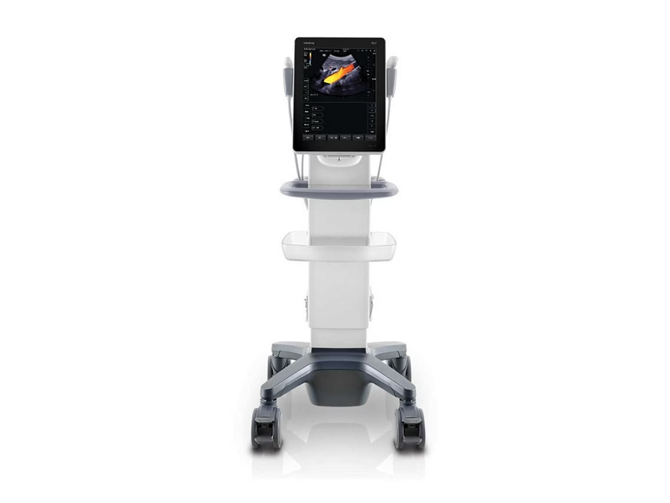 Mobile ultrasound machine on a wheeled stand with a touchscreen monitor displaying an ultrasound image in grayscale and color doppler accents.