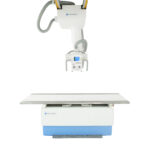 Konica minolta medical x-ray machine with an overhead gantry and a flat examination table against a white background.