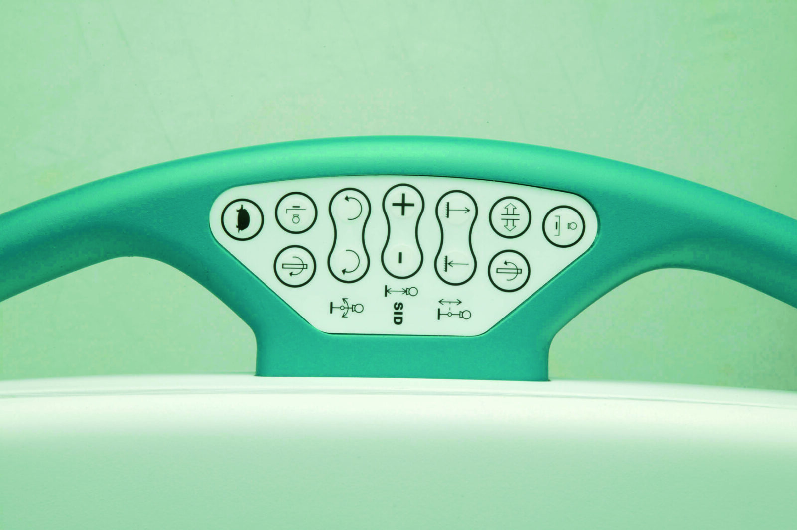 Close-up of a curved teal control panel with multiple circular buttons and icons for adjusting position on a chair or bed.