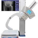 Medical imaging device with patient table and a monitor showing a pelvic x-ray image