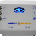 Medical device control panel featuring a blue backlit gauge in the center and six knobs with directional icons, labeled 'amrad medical' below.