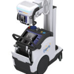 Portable cart-mounted medical imaging system with dual screens and a robotic arm, ready for procedures.