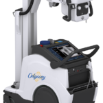 Portable c-arm x-ray machine on a wheeled cart with a control console labeled odyssey.