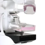 Dental panoramic dental x-ray machine with a pink bite block and floral wall in the background, ready for imaging.
