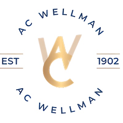 Circular ac wellman logo with a gold intertwined monogram at the center; 'ac wellman' text around the circle and 'est 1902' on the left and right.