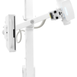 Ceiling-mounted medical x-ray imaging system with a vertical support column and an adjustable articulating arm ending in the imaging panel on the right side of the image.
