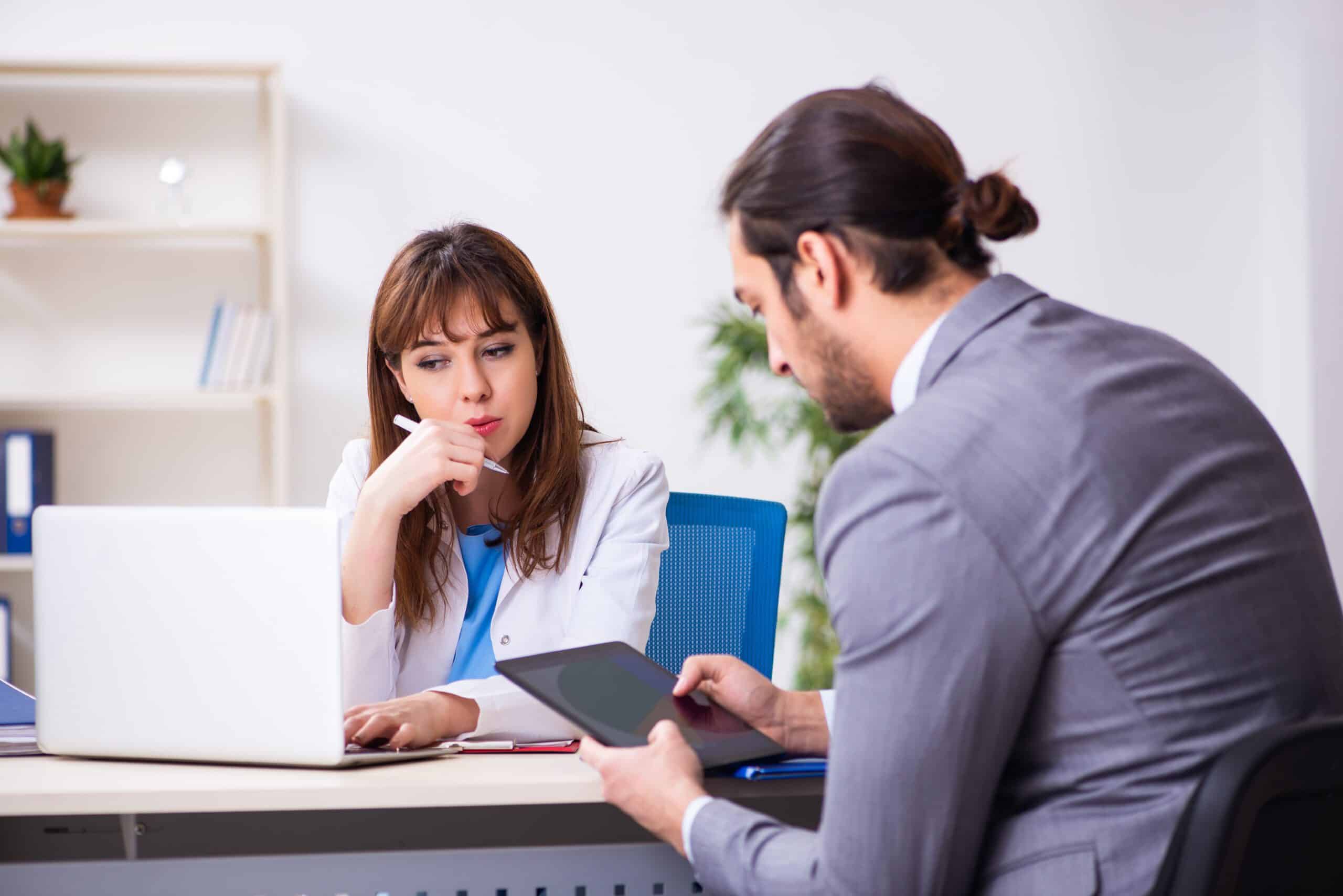 Adobestock_386077295-scaled Female doctor and businessman in an office