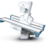 Medical ct scanner with patient table ready for imaging, showing the gantry and horizontal table.