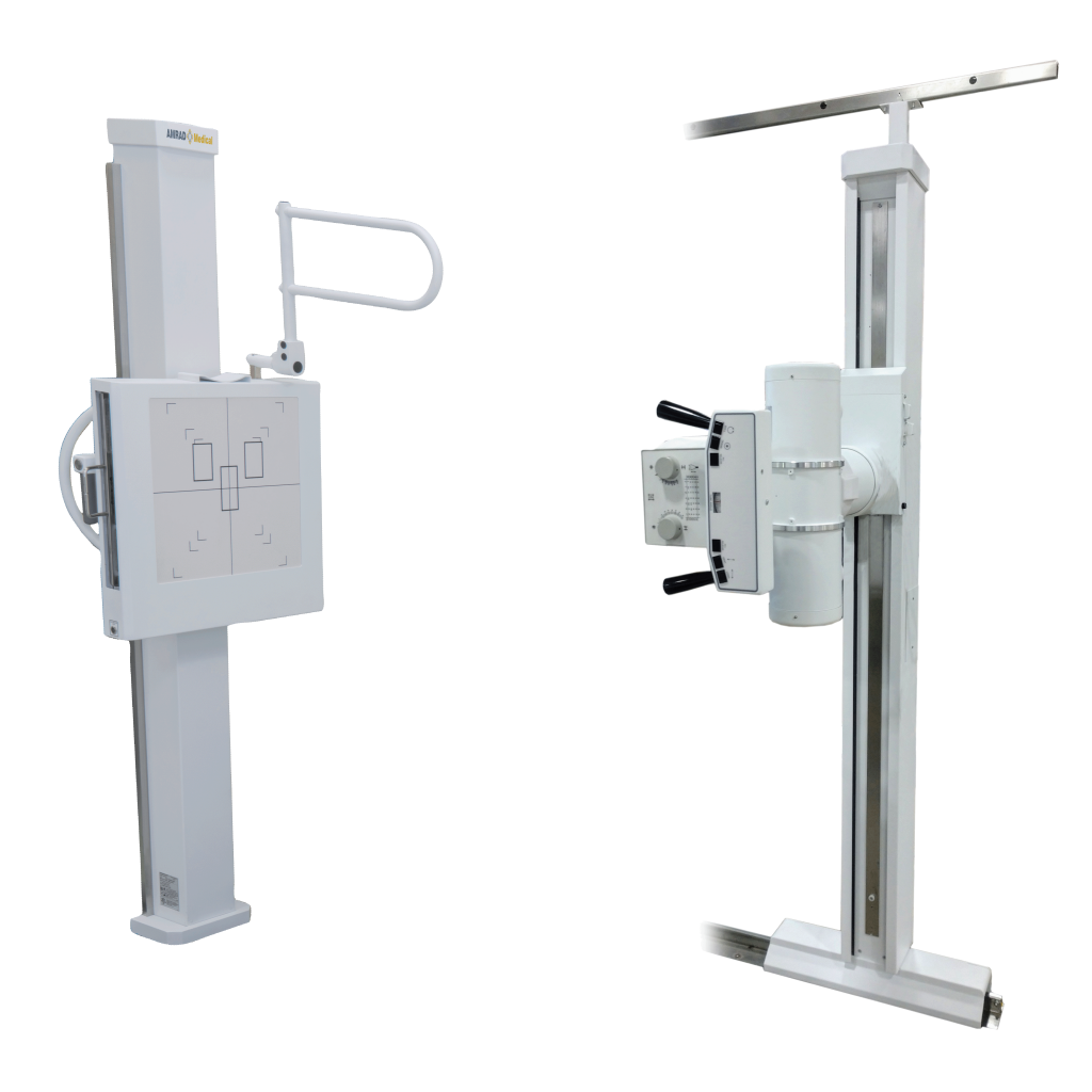 Two white radiography machines on tall stands facing each other, with control panels and patient positioning arms.