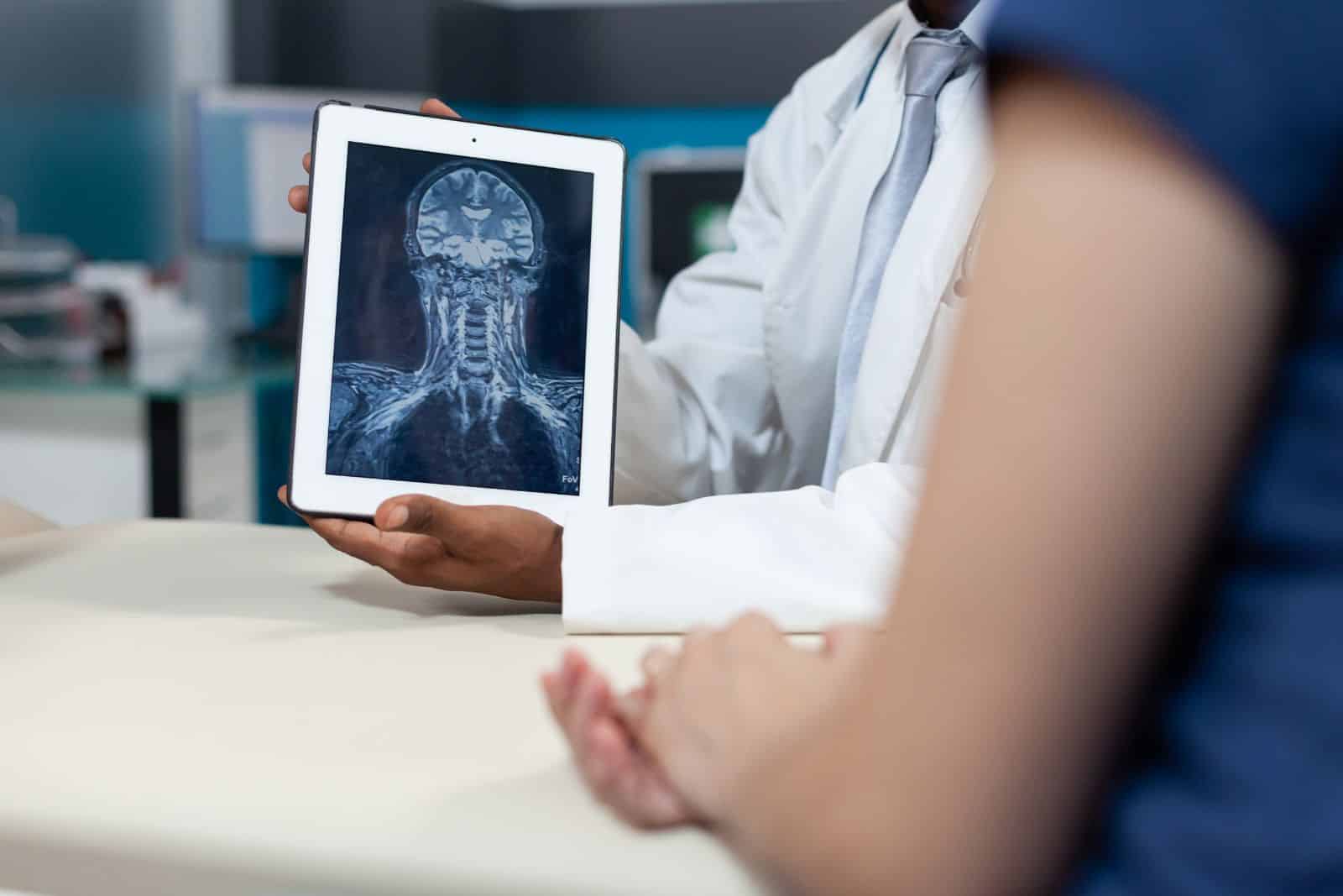 Closeup-african-american-radiologist-holding-tablet-with-bones-radiography-1