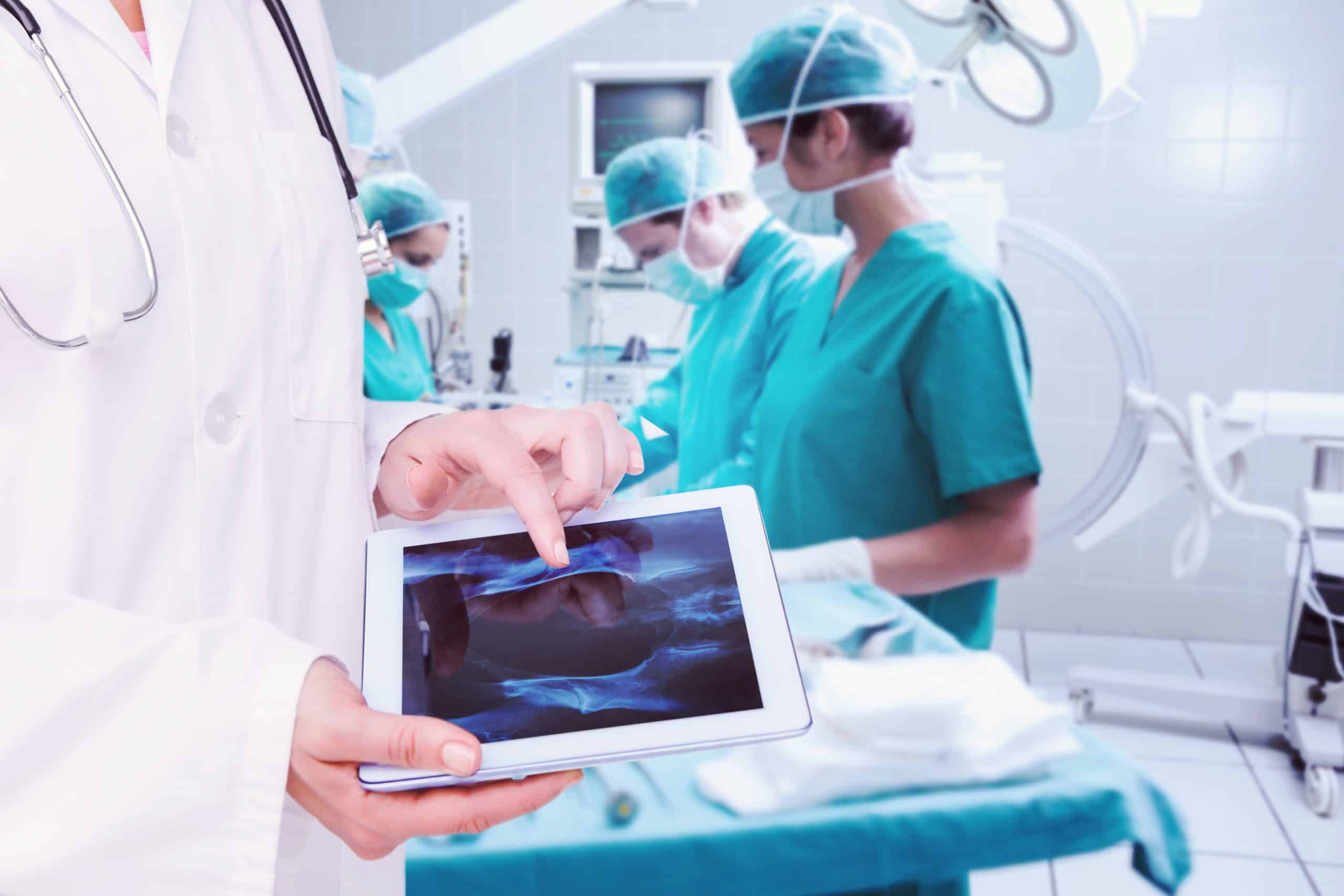 Composite-image-doctor-looking-xray-tablet-scaled