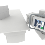 Medical imaging setup with a horizontal patient table and a control console on a movable arm (x-ray/radiography system).