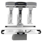 Three robotic surgical arms mounted over a patient table, ready for operation.