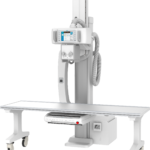 Medical x-ray imaging system with a vertical column, control panel, and wheeled patient table.