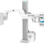 Medical x-ray imaging system on a stand with vertical column, horizontal arm, and diamond control console labeled drgem logo at top.