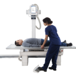 Patient lies on an x-ray table as a clinician in blue scrubs positions a tall imaging unit with a monitor above them.