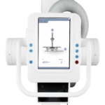Medical imaging device with a tall column and screen, likely an x-ray or radiography machine used for patient positioning and imaging supervision.
