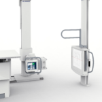 Medical imaging system with tall white gantry pillars and a control monitor labeled del medical on the left side of the scene.