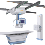 Ceiling-mounted radiography system with horizontal rails and a patient table, used for diagnostic x-ray imaging.