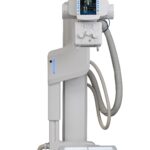 Medical x-ray imaging system on a tall stand with a control console and patient table below