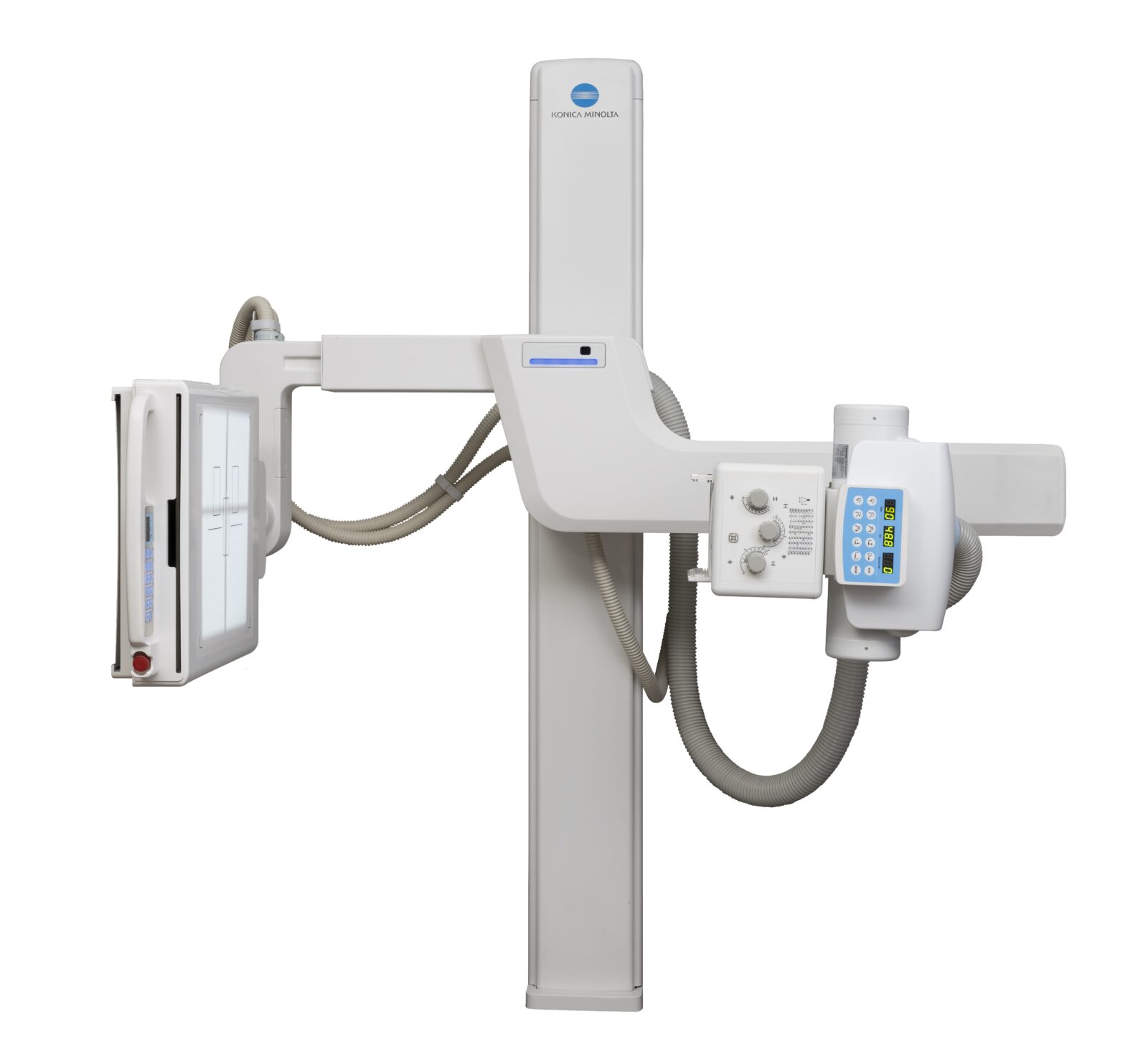 Medical x-ray imaging system with a vertical column and blue konica minolta logo, shown in a cross-table setup.