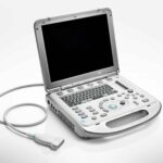 Portable ultrasound machine with a screen, keyboard, and a connected transducer probe on a white background.