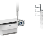 Radiology imaging setup with a patient table on the left and a tall vertical imaging unit on the right (del medical).