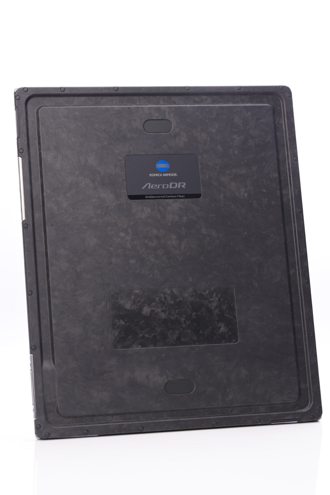 Back view of a dark aerodr device with a blue konica minolta badge and textured surface.