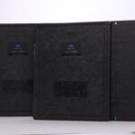 Back view of three black aerodr imaging panels with konica minolta branding on a white surface/wall.