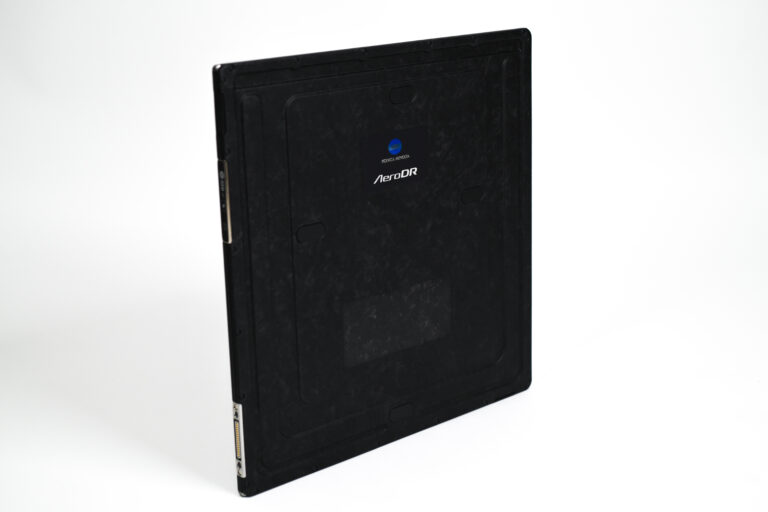 Back view of a black konica minolta aerodr radiography detector with blue logo and branding visible