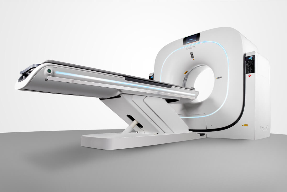 Ct scanner with sliding patient table extending toward the circular gantry in a clean medical setting