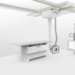 Ceiling-mounted medical imaging system with a horizontal x-ray table and control console in a clean white room (del medical).