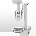 Vertical medical imaging machine with a control display and overhead components; del medical branding visible—likely an x-ray system.