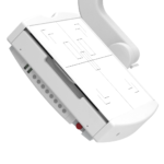 Angled view of a white medical printer-like device with a paper tray and printed sheets showing outlines and grids, in a clinical setting.