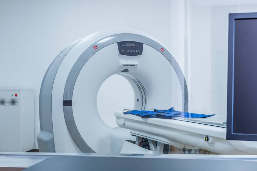 Mri scanner with a patient table ready for scanning in a clinical room
