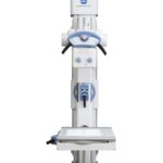 Vertical konica minolta radiography machine with blue controls and patient table