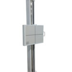 Tall white industrial cabinet on a vertical silver post with a t-shaped top arm, mounted on a white base.