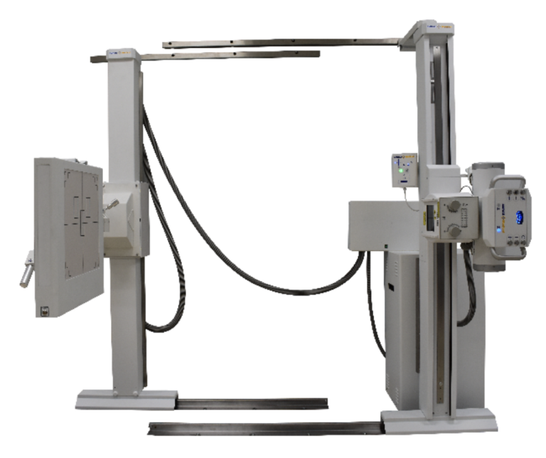 Industrial x-ray imaging gantry with vertical columns and horizontal beam arms, connected by cables, and control panels on the right side.