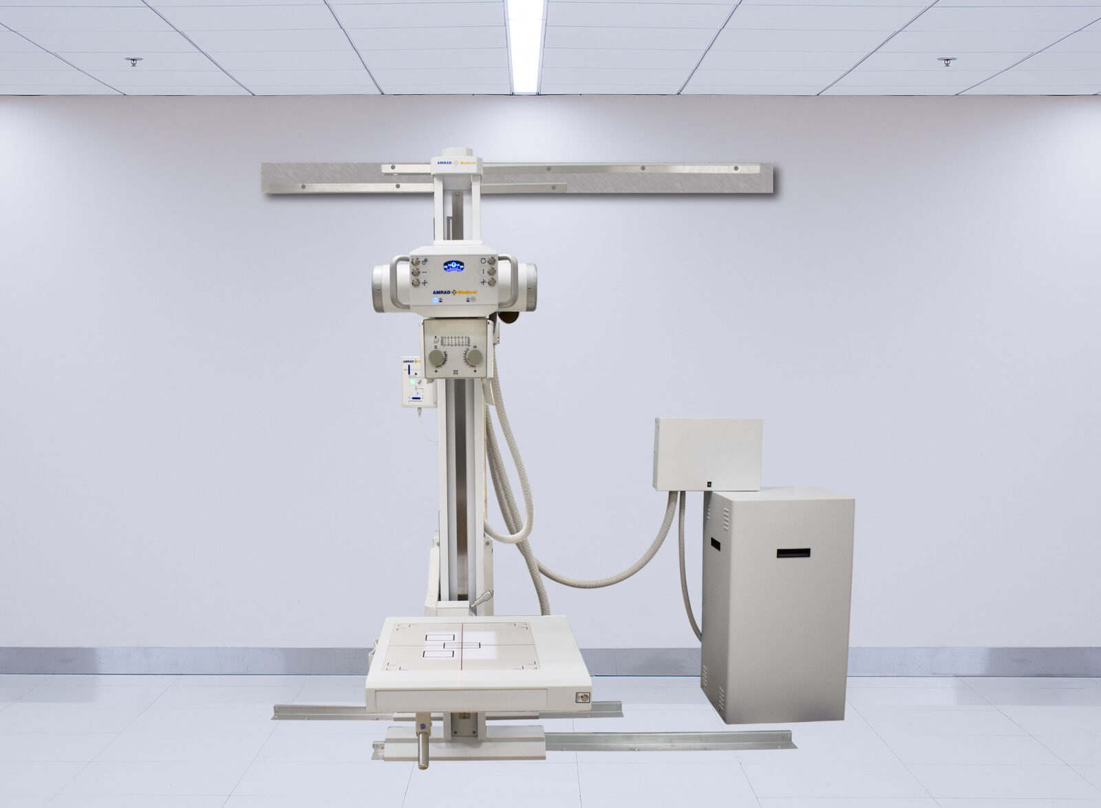 Medical x-ray imaging machine mounted on a vertical stand in a stark, clean radiology room.