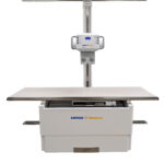 Medical operating table with vertical support column and control panel, amrad medical branding, set against a white background