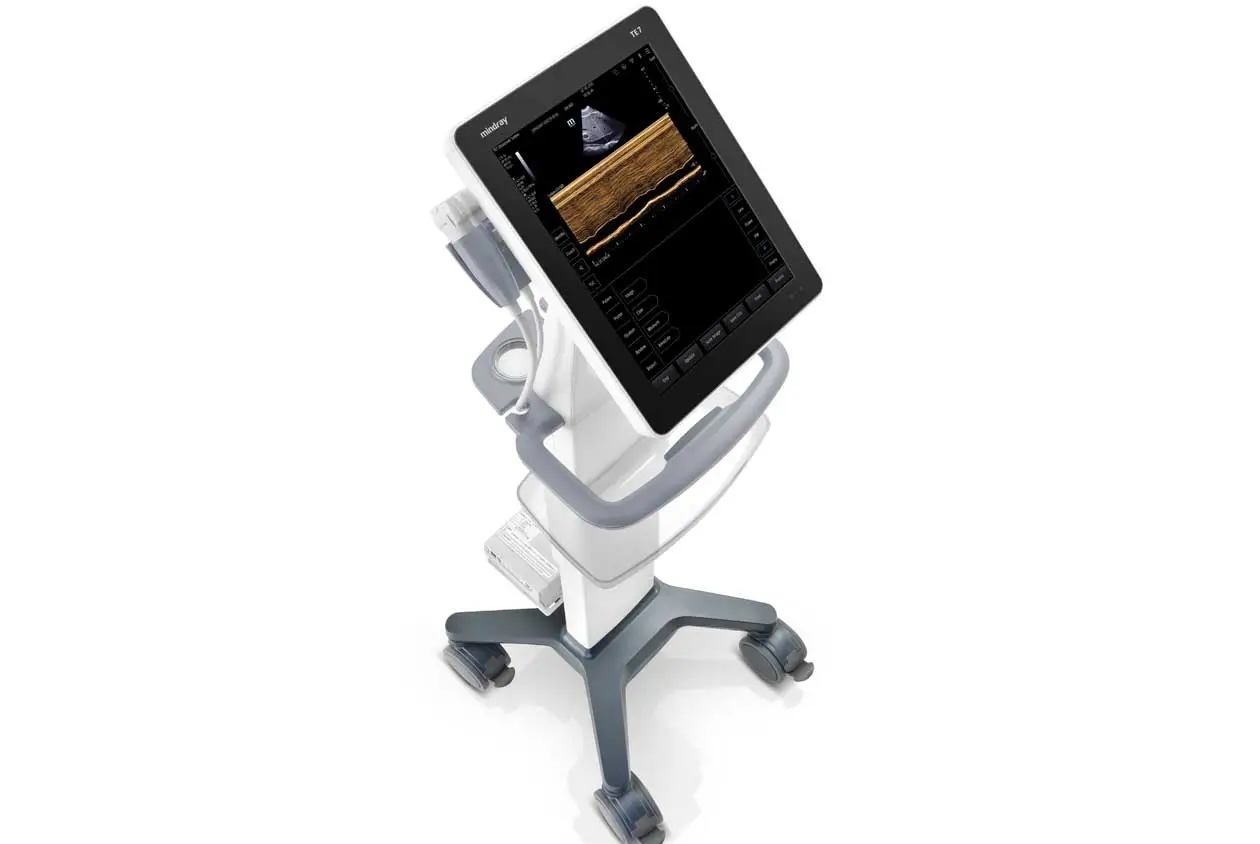 Portable ultrasound machine on a wheeled cart with a monitor and probe holder, angled as if ready for use