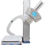 Medical x-ray imaging system with a vertical stand, control panel, and curved imaging arm for diagnostic scans.