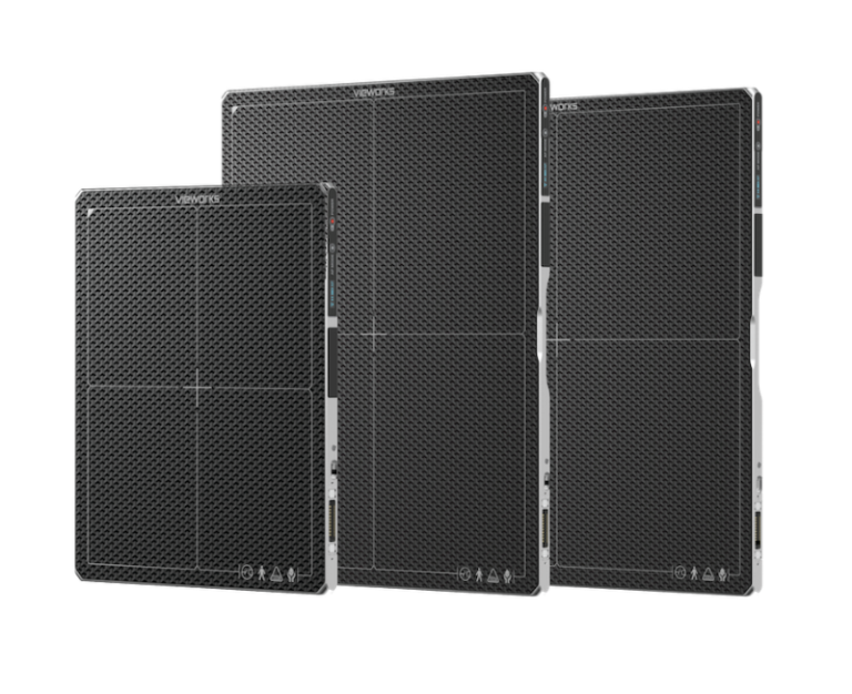 Three black professional loudspeaker cabinets with metal mesh grilles arranged in a row at an angle.