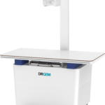 Drgem x-ray imaging system with a tall stand, horizontal patient table, and a control console mounted above the table edge.