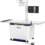 Medical x-ray imaging system with a tall vertical column, a curved overhead unit bearing the drgem logo, and a side screen displaying a spine x-ray image for radiography.