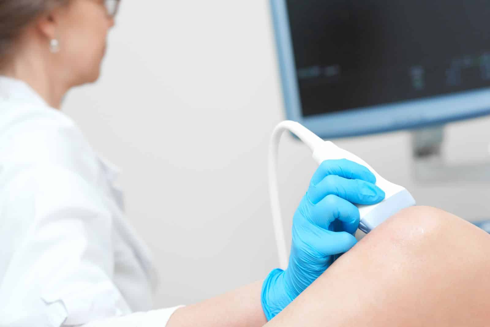 Woman-getting-knee-ultrasound-scanning-examination-clinic-1