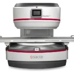 Open mri scanner (magnifico open by saote) with the patient table extended, ready for imaging in a white-gray unit with red accent stripe.