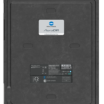 Rear view of a black konica minolta aerodr detector with a centered sticker label and engineering details on a metal backplate